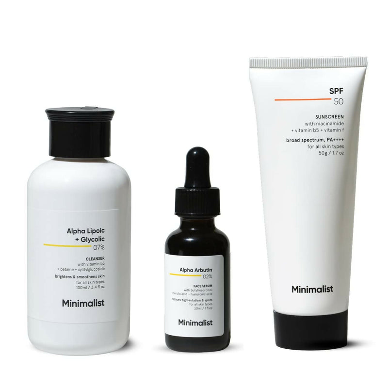 A set of three minimalist skincare products including a cleanser, a serum, and a sunscreen, each packaged in simple white bottles with clear labels.
