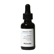 Black bottle of face serum with dropper labeled 'Minimalist' on a white background