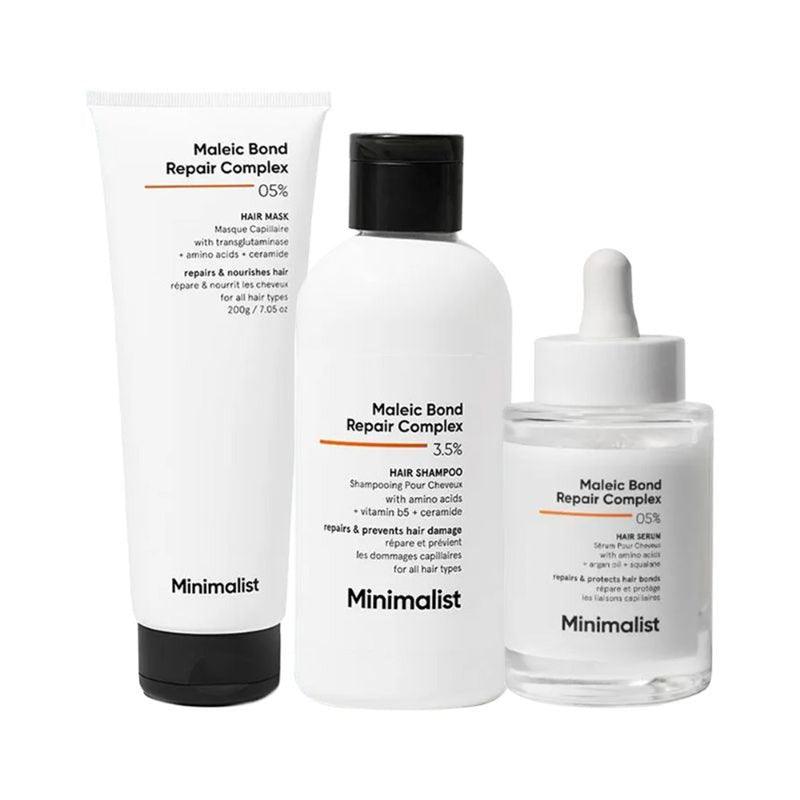 Minimalist hair care product set including shampoo, mask, and serum on a white background