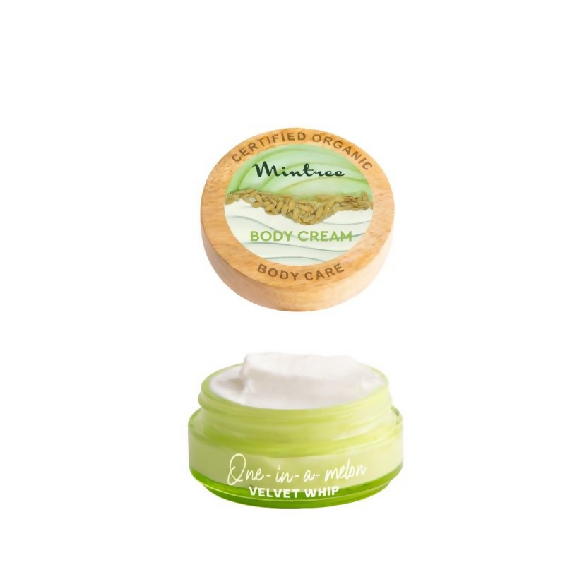 Green body cream jar with wooden cap on a white background