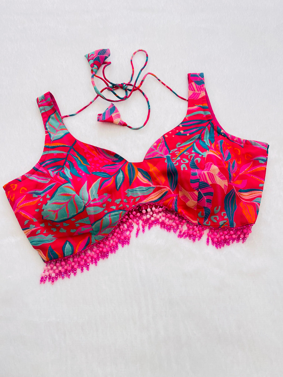 Colorful bikini set with fringes on a light gray background