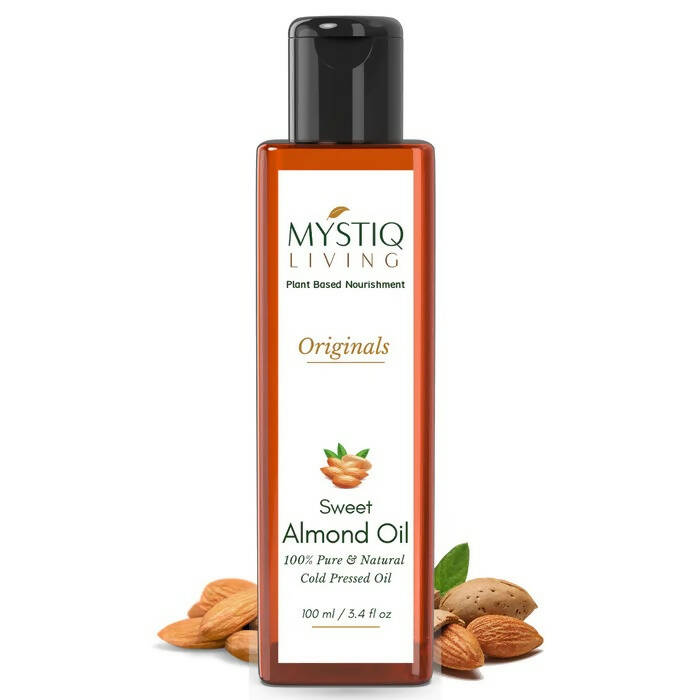 Bottle of Mystiq Living Sweet Almond Oil with almonds on a white background