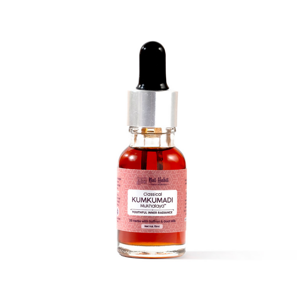 Bottle of Kumkumadi oil with a dropper on a white background