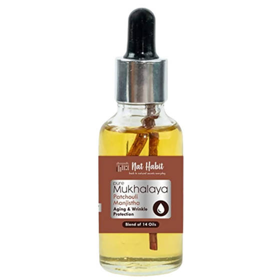 Bottle of Pure Mukhalaya oil with a dropper on a white background