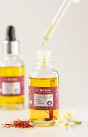 Bottle of Mukhalata oil with a dropper on a light background