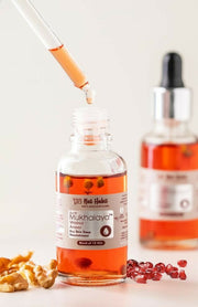 Bottle of Mukhalayya with dropper and ingredients on a light background