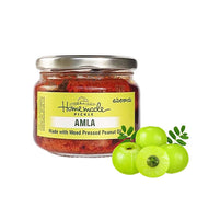 Jar of Amla pickle with amla fruits on a white background
