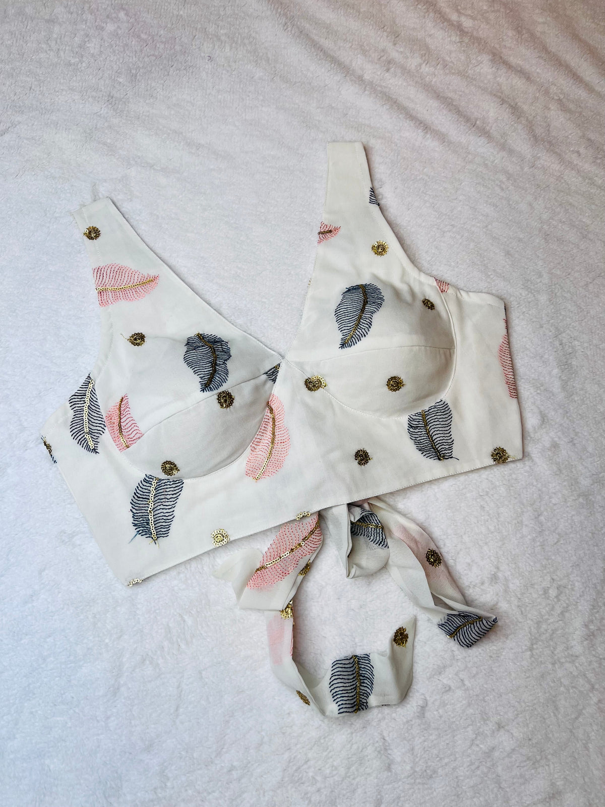 Fabric bra with decorative straps on a light background