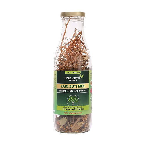 Glass jar with dried herbs labeled 'Jadi Buti Mix' on a white background