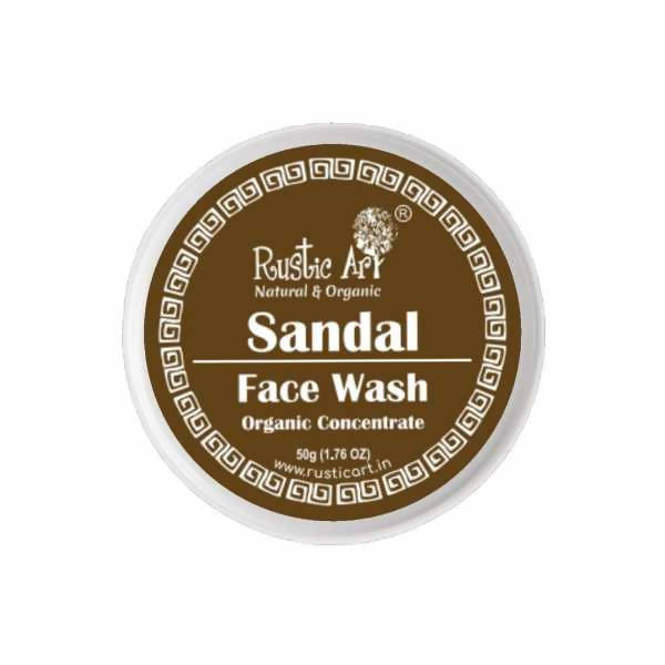 Rustic Art Sandal Face Wash Organic Concentrate in a round brown bottle with a white cap, labeled with the brand and product details.