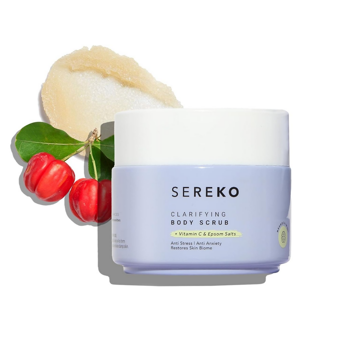 Sereko clarifying body scrub with a scoop of scrub and red fruits on a white background