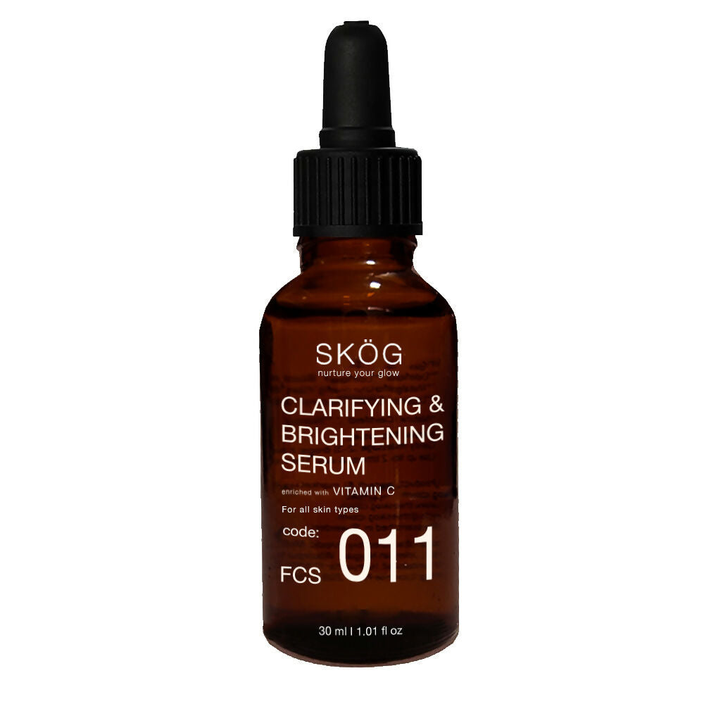 Brown serum bottle with dropper labeled 'SKØG Clarifying & Brightening Serum' on a white background