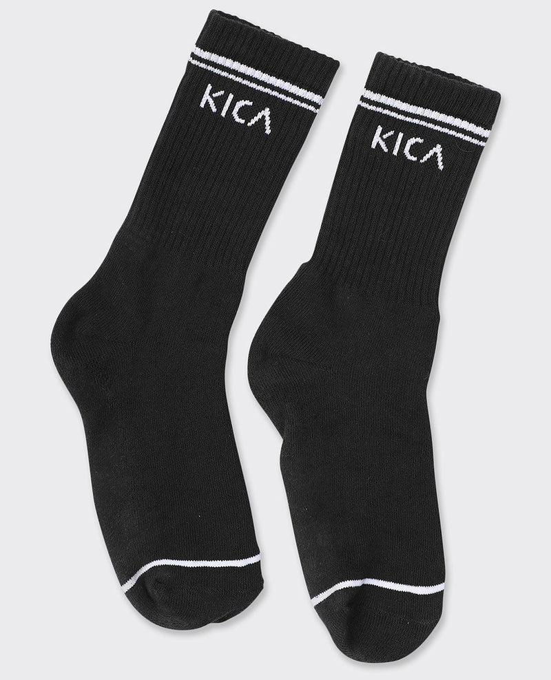 Black socks with white stripes and 'KICA' branding on a light gray background