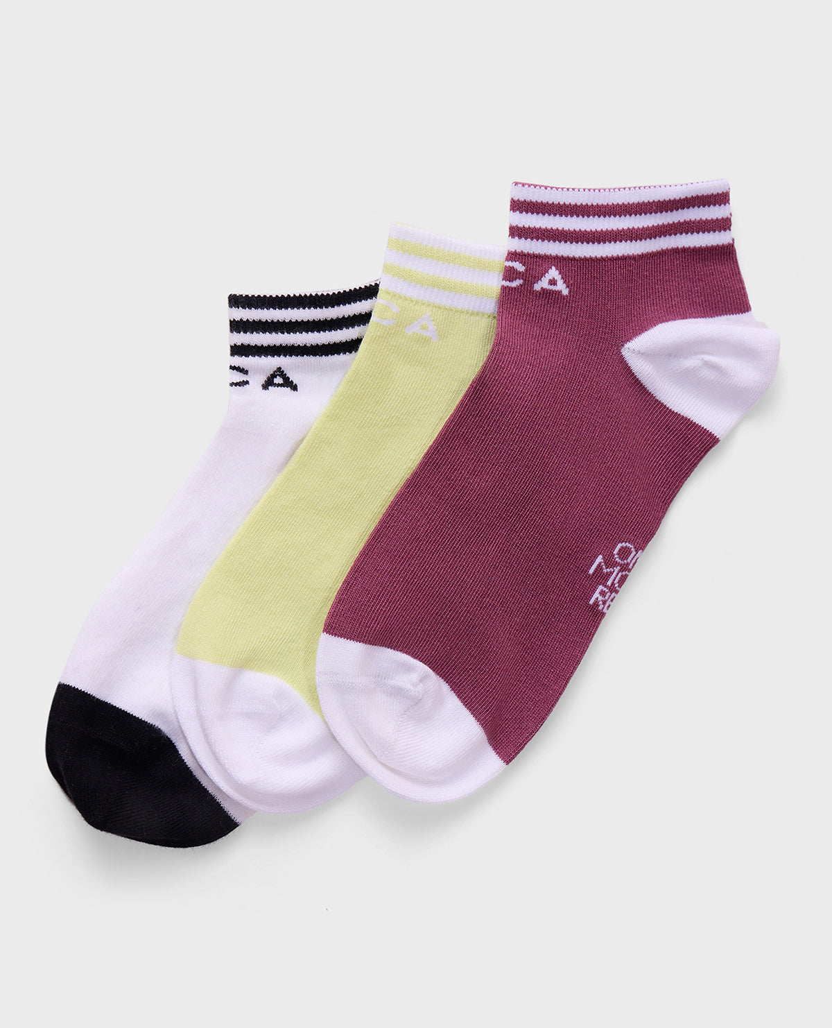 Three pairs of socks in white, yellow, and maroon with branding on a light gray background