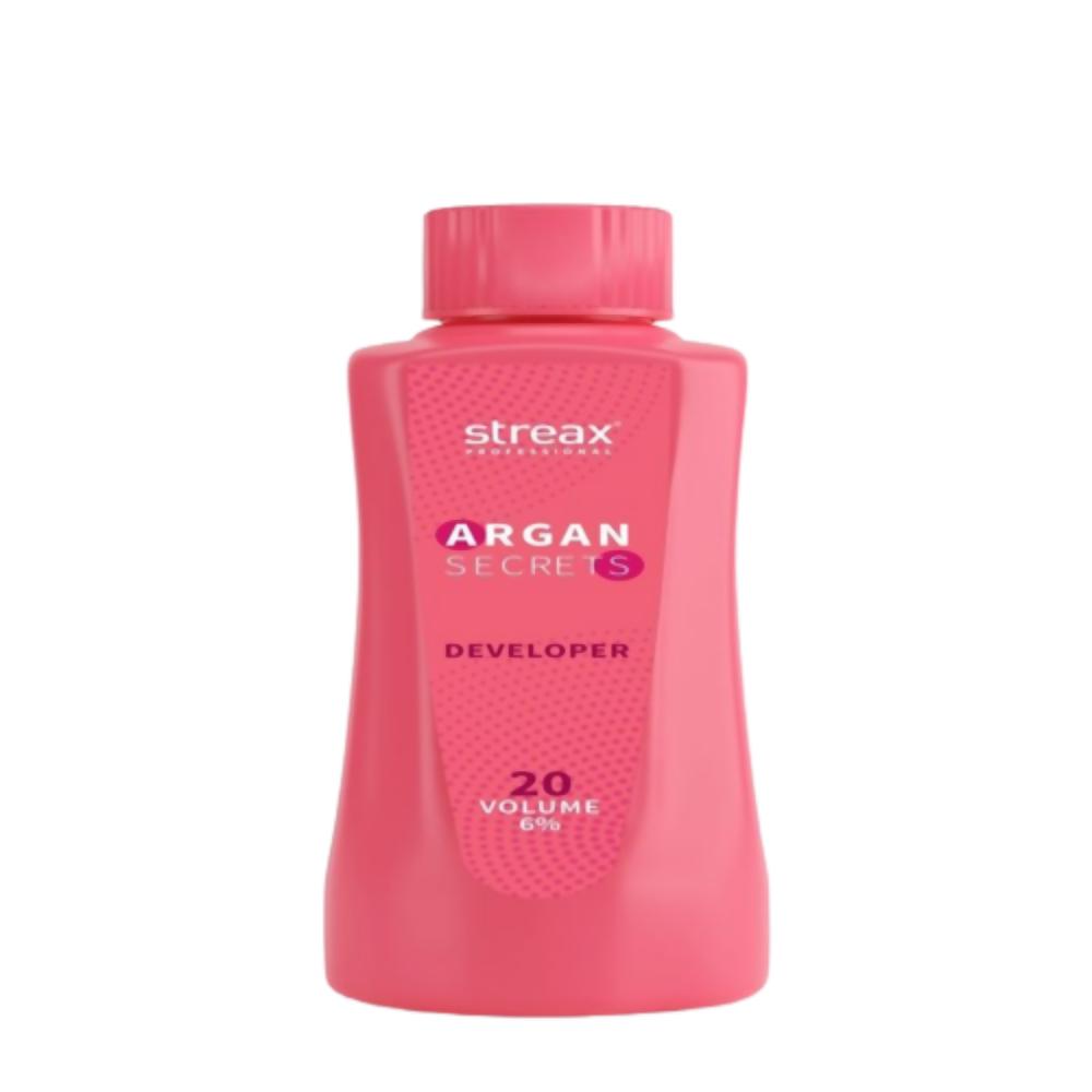 Pink bottle of streax Argan Secrets Developer on a white background