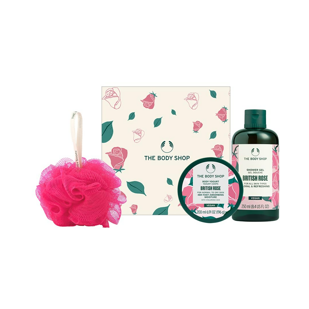 The Body Shop British Rose product set including a loofah, shower gel, and bath bomb on a white background.
