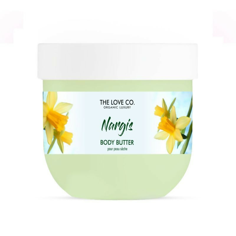 Green jar of 'Nangis' body butter from 'The Love Co.' with daffodil flowers on a white background
