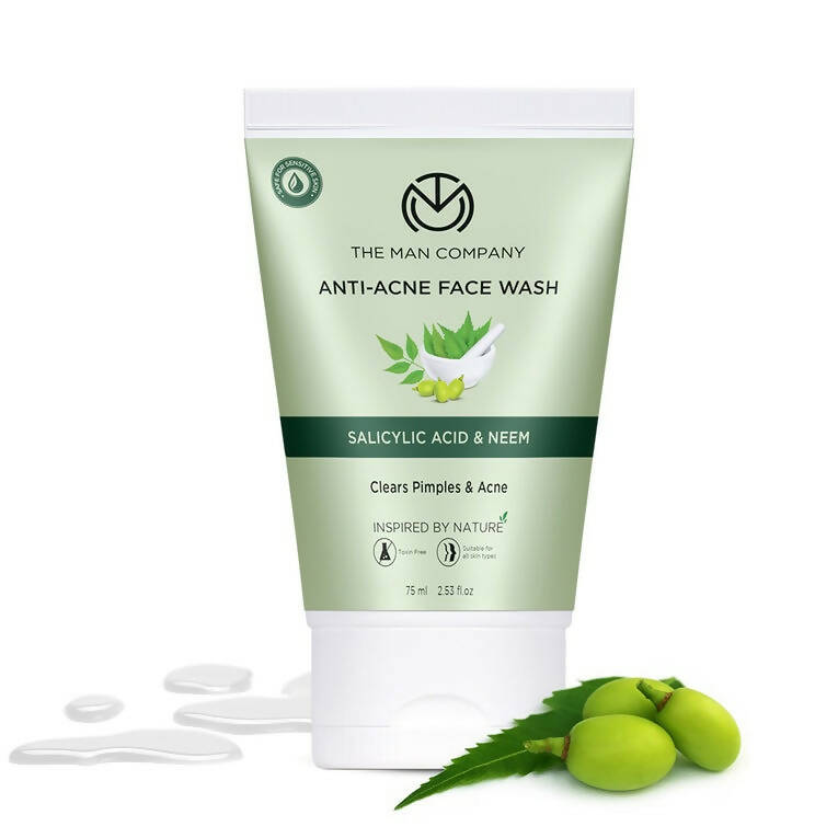 Anti-acne face wash tube with green leaves and neem fruits on a white background