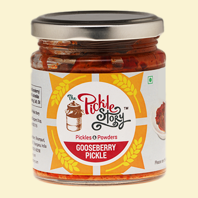 Jar of gooseberry pickle with 'The Pickle Story' label on a beige background