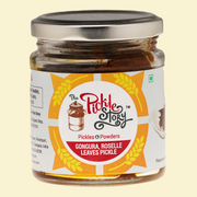 Jar of 'The Pickle Story' Gongura Roselle Leaves Pickle on a beige background