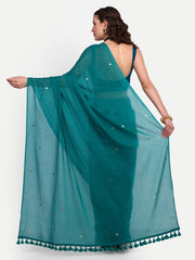 Woman wearing a teal saree with a white background