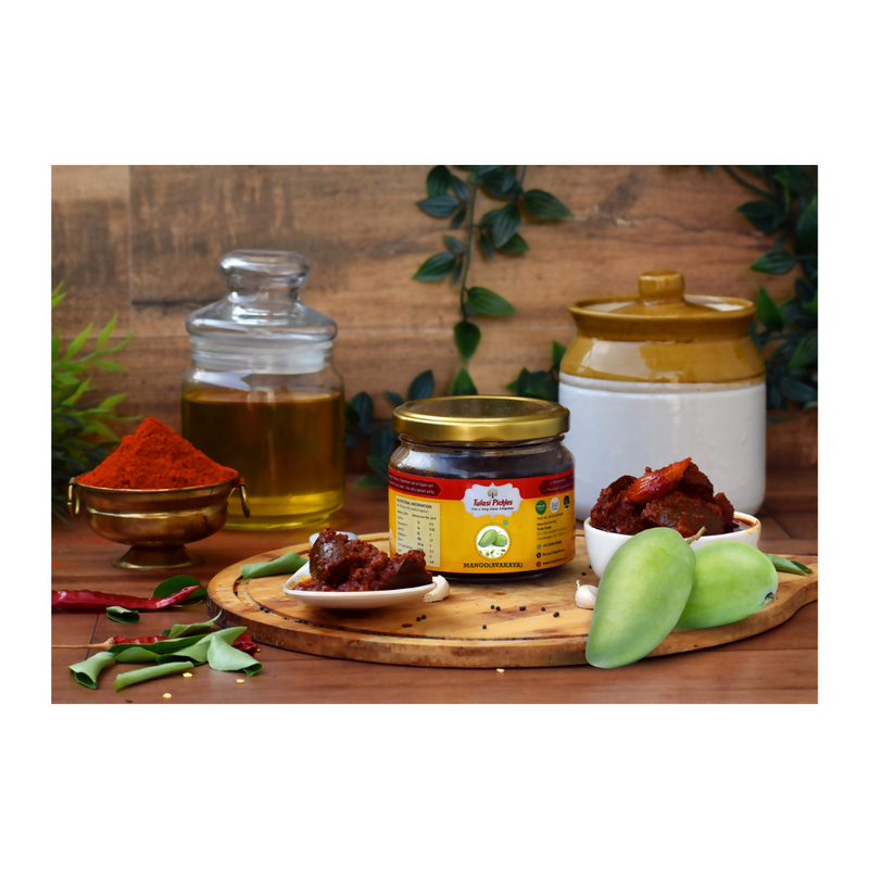 Assorted food items including a jar, oil, and spices on a wooden surface with a rustic background.