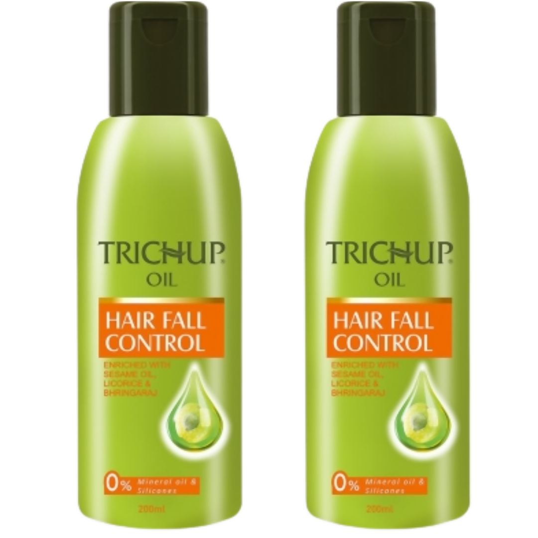 Two bottles of Trichup Hair Fall Control oil on a white background