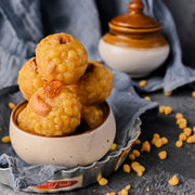 Breaded and fried food items in a bowl with a blurred background