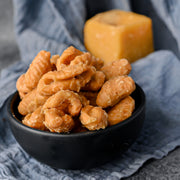 Nuts in a black bowl on a blue textured surface