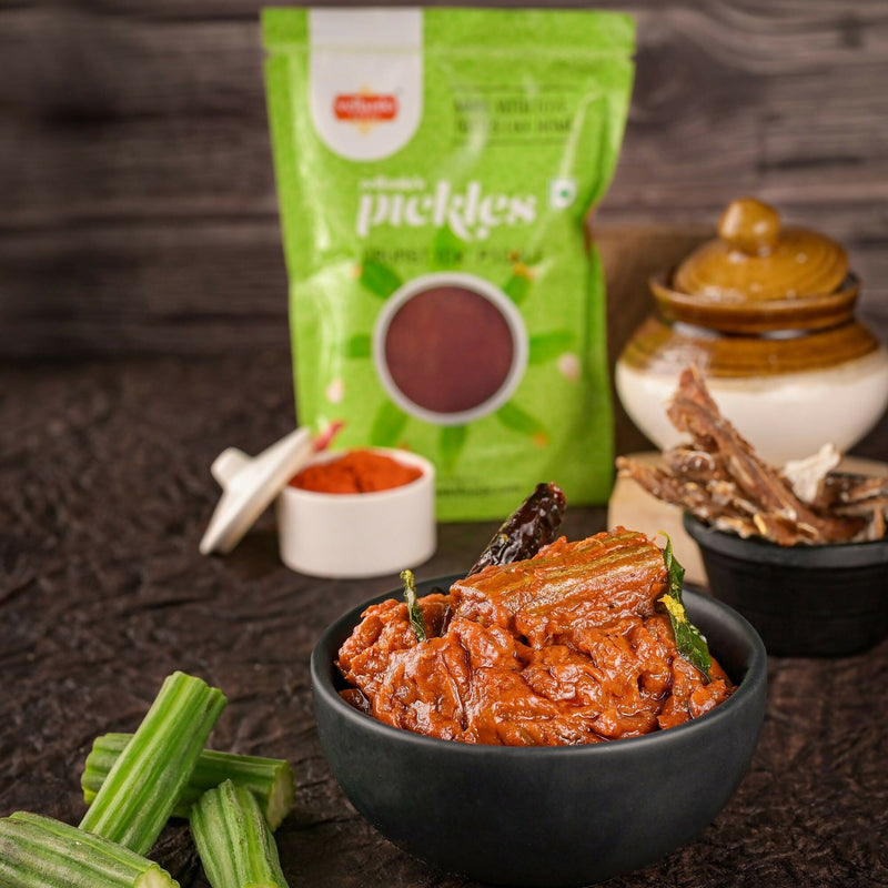 Pickled vegetables in a bowl with a green packet labeled 'pickles' in the background.