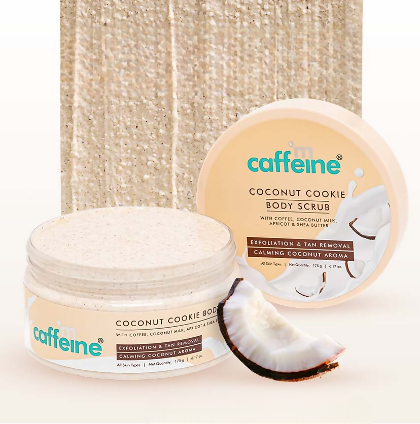 Two containers of caffeine coconut cookie body scrub with a coconut half on a textured beige background