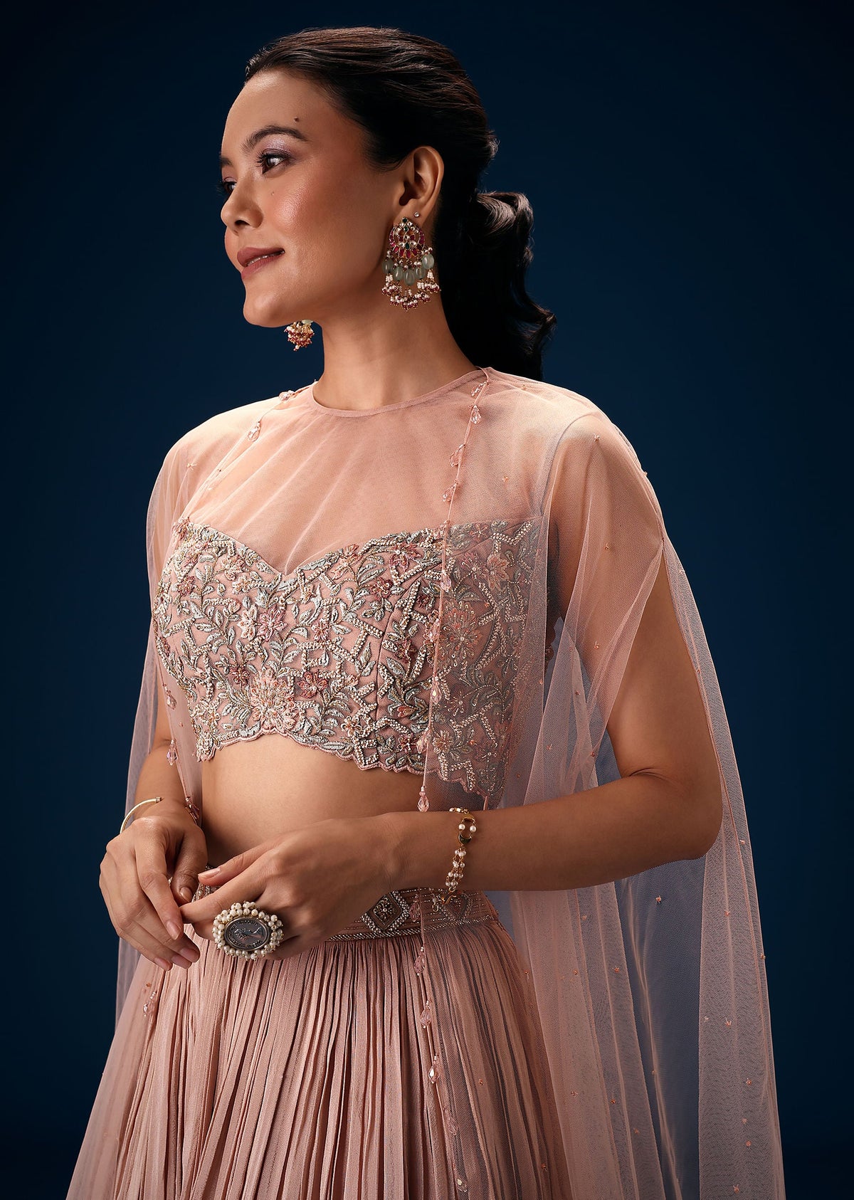 Peach Ruched Lehenga With Embroidered Blouse and Net Cape