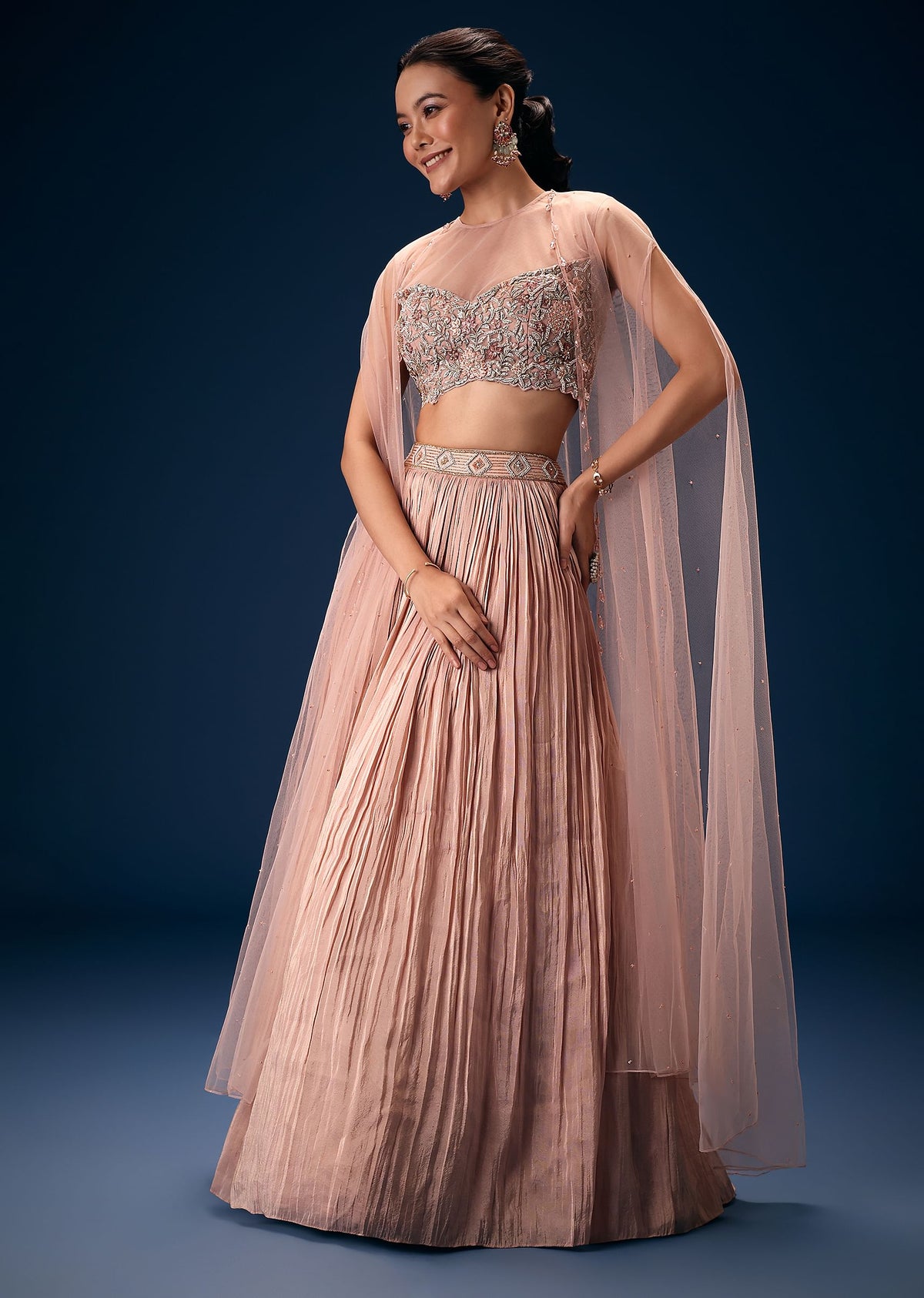 Peach Ruched Lehenga With Embroidered Blouse and Net Cape
