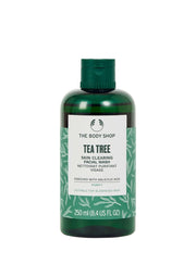 The Body Shop Tea Tree Skin Clearing Facial Wash in a green bottle with white and black labeling, containing 250 ml of product.